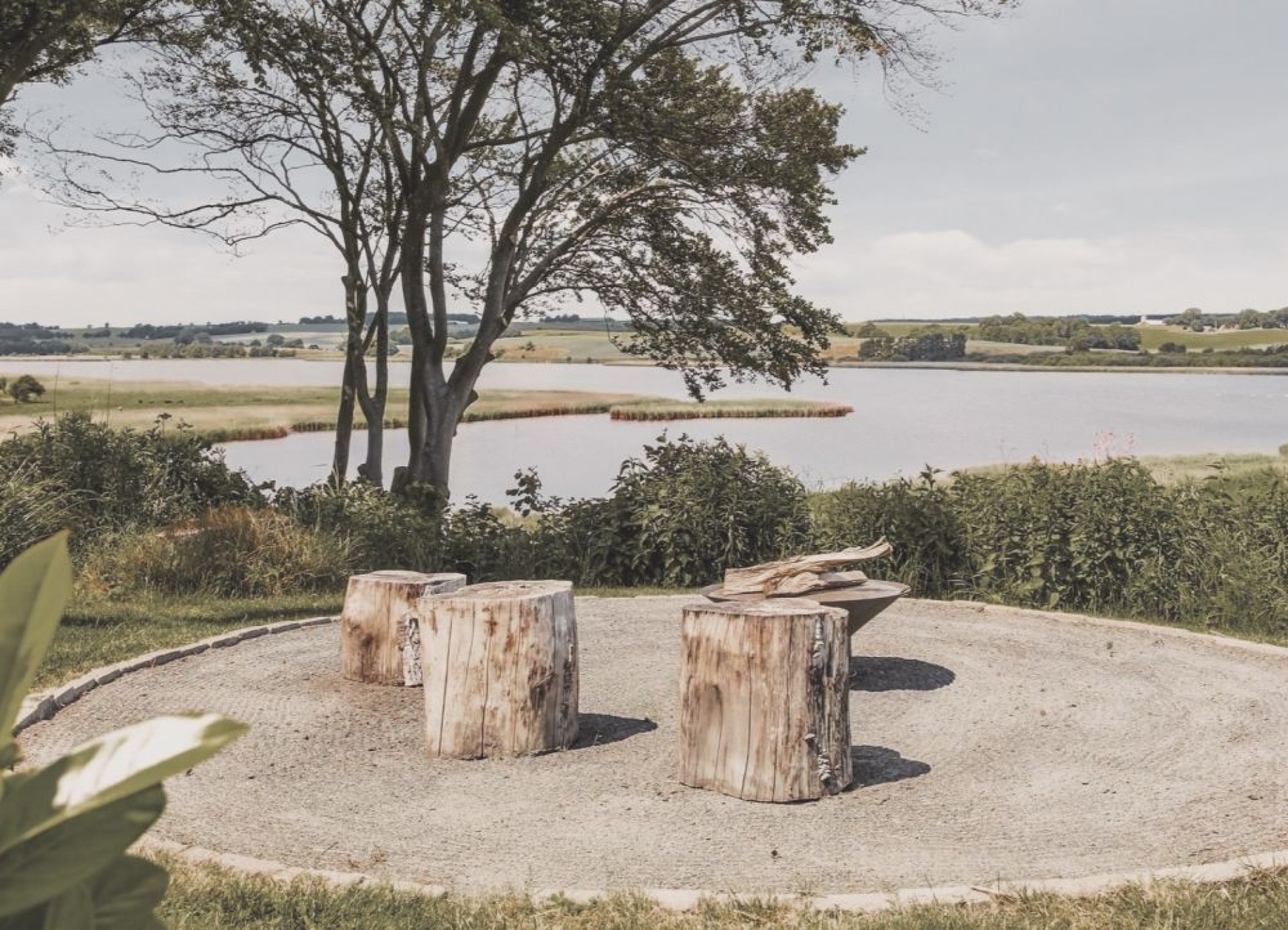 Bålpladsen ved Villa Solbakkevej Bålplads med træstupper med udsigt over vandet